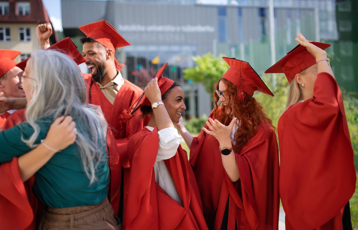 Group Of Cheerful University Students Celebrating Outdoors, Graduation Concept. A group of cheerful university students celebrating outdoors, graduation concept.